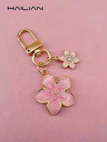 HAILIAN 这款轻巧优雅的樱花造型钥匙扣采用合金材质，专为女性设计，并饰有六瓣樱花吊坠。它是完美的旅行配件，可用作包包挂饰或车钥匙扣，也是情侣生日和节日的理想礼物。 - 粉色 - 查看 9