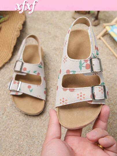 儿童凉鞋，舒适柔软的鞋底，时尚百搭，是女童的理想之选。浅底印有樱桃和小雏菊图案，清新活泼。双扣设计可根据脚型调节，有效防止鞋子脱落。适合儿童日常出行和校园穿着。
