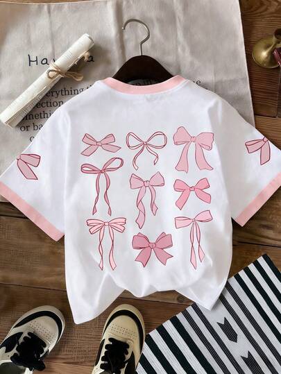 Áo thun nữ tuổi teen màu hồng in hình nơ, chất liệu mềm mại, thoải mái cho mùa hè.