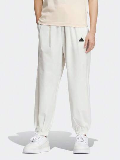  Quần jogger dáng lửng, màu trơn, in logo adidas, dành cho nữ, màu trắng ngọc.