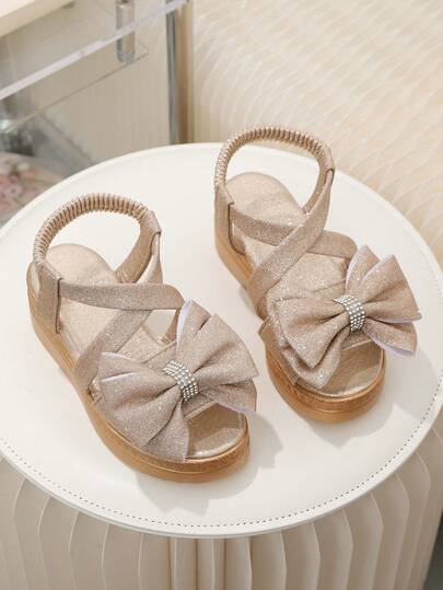 1 par de sandalias de plataforma con cuña y diseño de lazo y strass, con brillo dorado, para niñas pequeñas y bebés, de estilo slip-on y punta cerrada, adecuadas para uso diario, casual, playa, escuela y fiesta, para niñas de 3 a 15 años, primavera/verano 2026