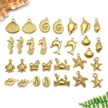 2 piezas Colgantes de metal de animales marinos de acero inoxidable dorado, con diseños de estrella de mar y delfín, para hacer joyería de verano y playa - Dorado - Ver 2