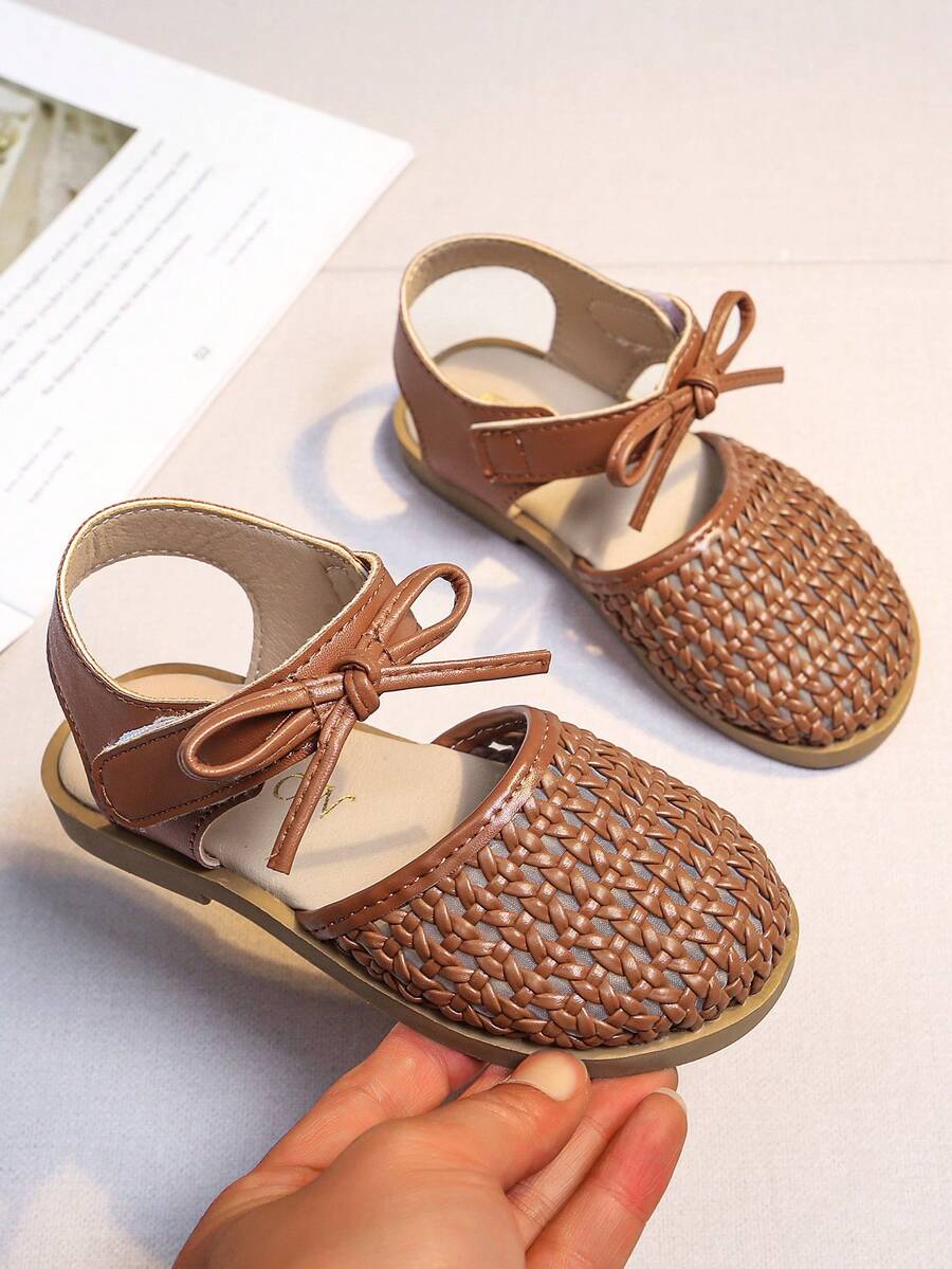 Dép xăng đan dệt cho bé gái, kiểu dáng công chúa mùa hè mới, nơ rỗng thoáng khí, đế mềm chống trơn trượt, dép trẻ em cho bé gái mẫu giáo. - màu nâu - Xem 1