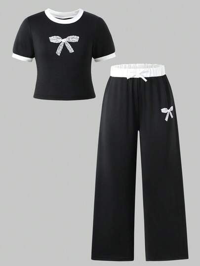 Bộ 2 món cho bé gái tuổi teen: Áo croptop phối màu tương phản có nơ và quần ống rộng thoải mái, thích hợp cho mùa hè.