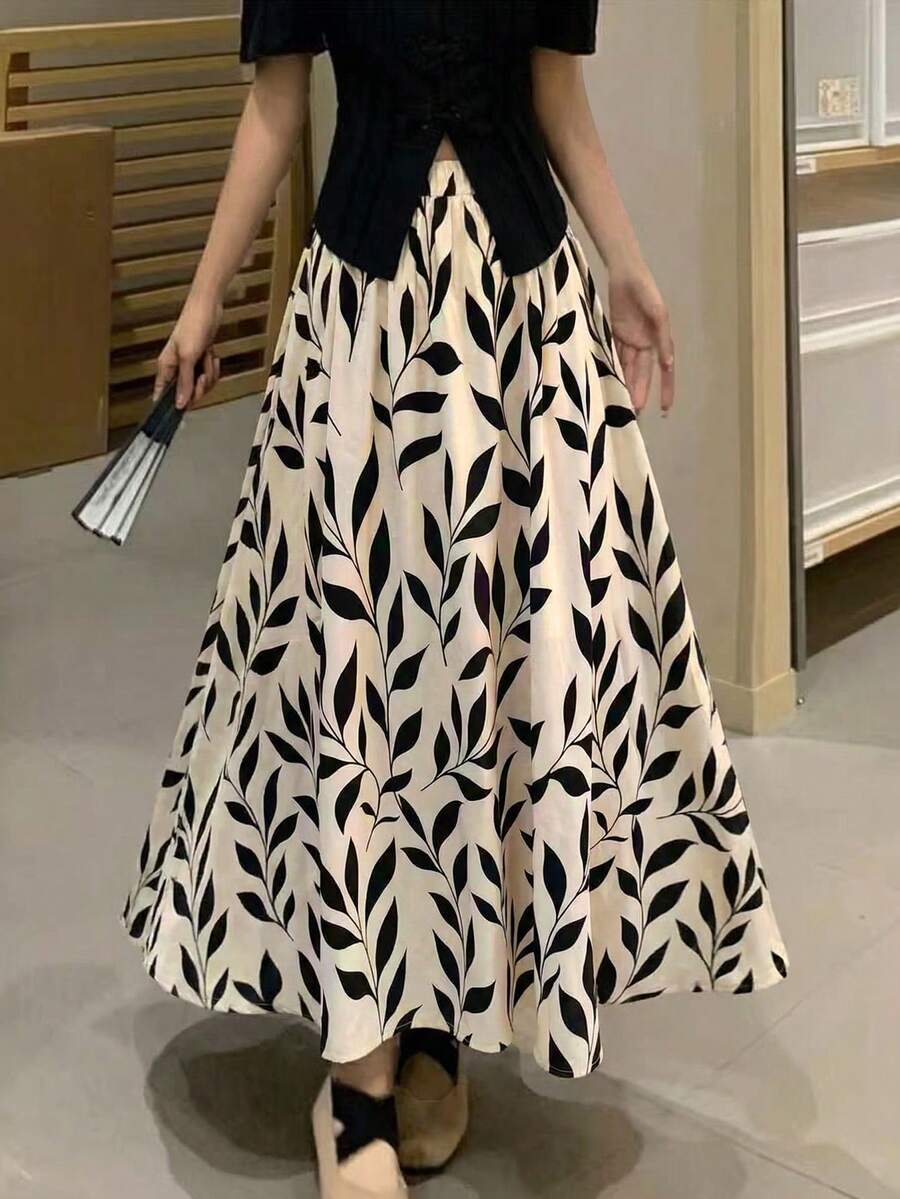 Falda larga de línea A con estampado de hojas elegante para mujer EARO, tela no elástica, cintura elástica, cómoda para usar en vacaciones de primavera - Base de albaricoque con negro - Ver 1