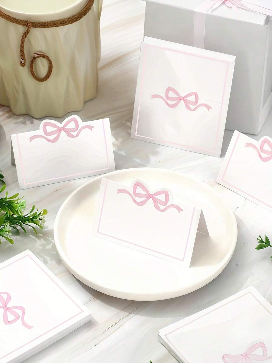 30/10 tấm thẻ ghi tên khách mời màu hồng có nơ, dùng trang trí bàn tiệc cưới, sinh nhật, làm quà tặng, phù hợp cho đám cưới, lễ đính hôn, sinh nhật và nhiều dịp khác - Thẻ ghi tên khách mời bằng giấy trắng. - Xem 1