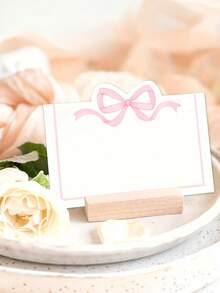 30/10 tấm thẻ ghi tên khách mời màu hồng có nơ, dùng trang trí bàn tiệc cưới, sinh nhật, làm quà tặng, phù hợp cho đám cưới, lễ đính hôn, sinh nhật và nhiều dịp khác - Thẻ ghi tên khách mời bằng giấy trắng. - Xem 4