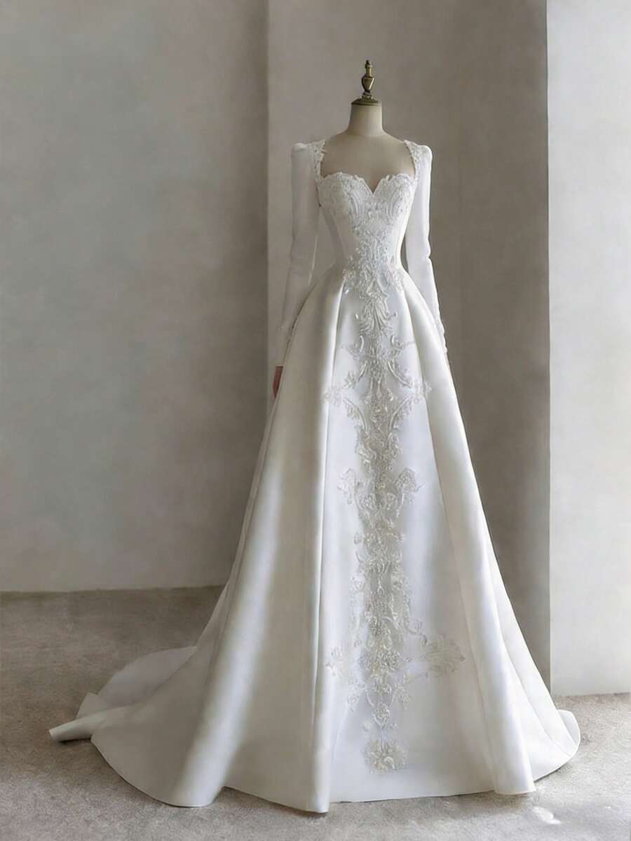 Elegant Sweetheart A-Line Wedding Dress With Long Sleeves And Floral Appliqué In Satin – Sophisticated Floor-Length Bridal Gown Featuring A Flattering Heart-Shaped Neckline, Full-Length Fitted Sleeves, Intricate Floral Embellishments, And Lustrous Satin Silhouette, Perfect For Weddings, Christmas Galas, Halloween Balls, Formal Dances, Birthday Celebrations, And Special Evening Events. A Versatile Choice For Wedding Receptions, Holiday Parties, Anniversary Dinners, Luxury Getaways, Black-Tie Occasions, Cocktail Gatherings, Bridal Showers, Wedding Guest Attire, Graduation Formals, Homecoming Events, And As A Modern Bridesmaid Or Festive Evening Gown. - 白色 - 查看 1