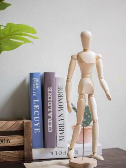 木制可动人体模型，可摆姿势，用于绘画素描，关节灵活，是艺术创作的理想选择。这款优质艺术用品适用于素描、绘画等艺术创作，也可作为复古木制工艺桌面摆件，简约风格，是家居、客厅、办公桌装饰的理想之选。此外，它还是一款极具收藏价值的木制人偶装饰摆件，是艺术学生练习人体素描的实用工具，也是创意十足的可摆姿势木制艺术模型，适用于家庭办公室装饰和艺术学习工艺摆件。