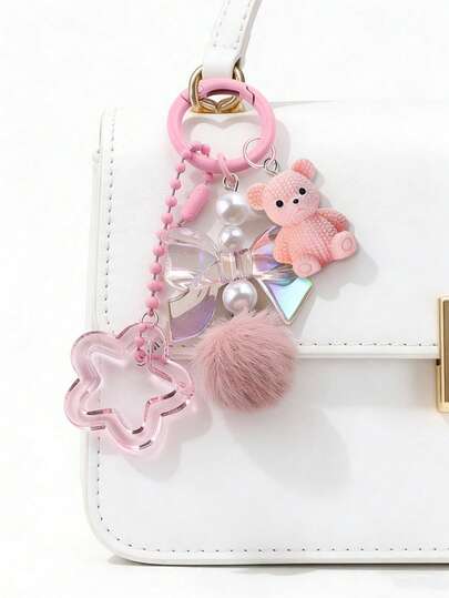 Móc khóa hình gấu dễ thương kèm nơ và ngôi sao, gồm gấu nhỏ, ngôi sao, dây hạt và mặt dây chuyền nơ lấp lánh. Được làm từ nhựa, phụ kiện thời trang phù hợp sử dụng tại nhà, làm móc khóa, trang trí bao bì, móc treo tai nghe, mặt dây chuyền ốp điện thoại, móc chìa khóa xe hơi hoặc phụ kiện trang trí túi xách. Có thể dùng cho túi xách/ba lô/máy tính xách tay, cũng là một món quà tuyệt vời cho ngày lễ/sinh nhật.