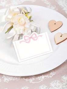 30/10 tấm thẻ ghi tên khách mời màu hồng có nơ, dùng trang trí bàn tiệc cưới, sinh nhật, làm quà tặng, phù hợp cho đám cưới, lễ đính hôn, sinh nhật và nhiều dịp khác - Thẻ ghi tên khách mời bằng giấy trắng. - Xem 5