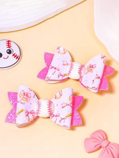 2个粉色棒球运动蝴蝶结发夹，世界杯垒球主题发饰，清新白色底，印满棒球和粉色蝴蝶结图案，饰以3D棒球和闪光侧边，质感亮丽，啦啦队发夹，运动赛事服装配饰，运动主题礼物，适合日常、校园等各种场合。