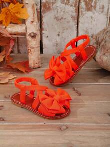 1 Paar orangefarbene Mädchen Flache Strand Sandalen, einfarbiger Stoff mit Schleifen Dekor, elastischer Kreuz-Rückenriemen Einteiliges Design, runde Zehenpartie, rutschfeste und strapazierfähige TPR Sohle, modische & niedliche römische Sandalen geeignet für 3-15 Jährige, Alltag, Party, Strand, Neu für den Sommer - Orange - Übersicht 7