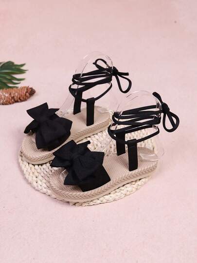 1 par de sandalias planas de playa, de unicolor con tela suave y decoración de lazo grande, correa elástica para el tobillo, punta redonda, suela flexible y antideslizante, sandalias romanas de estilo escolar bonitas y de moda para niñas, adecuadas para uso diario, playa y campus en primavera y verano