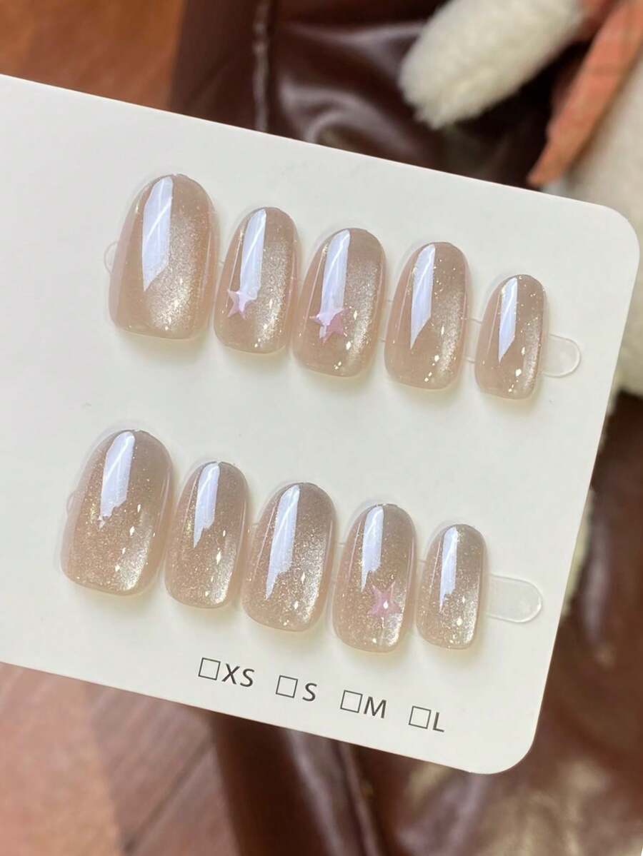 10片纯手工制作的按压式美甲，中号椭圆形美甲，香槟色美甲，梦幻星空风格，香槟渐变猫眼图案，手绘粉色星星，可爱简约的按压式美甲，适合女性和女孩，春夏秋冬节日派对及日常佩戴。 - 香檳色 - 查看 1