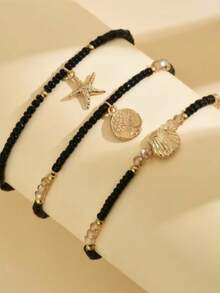 Tres piezas de tobilleras de mujer con temas de playa de verano que presentan colgantes con el árbol de la vida, estrella de mar y concha. Estas frescas y elegantes tobilleras están hechas con cuentas de arroz negro y cuerdas elásticas - Negro - Ver 2