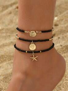 Tres piezas de tobilleras de mujer con temas de playa de verano que presentan colgantes con el árbol de la vida, estrella de mar y concha. Estas frescas y elegantes tobilleras están hechas con cuentas de arroz negro y cuerdas elásticas - Negro - Ver 1
