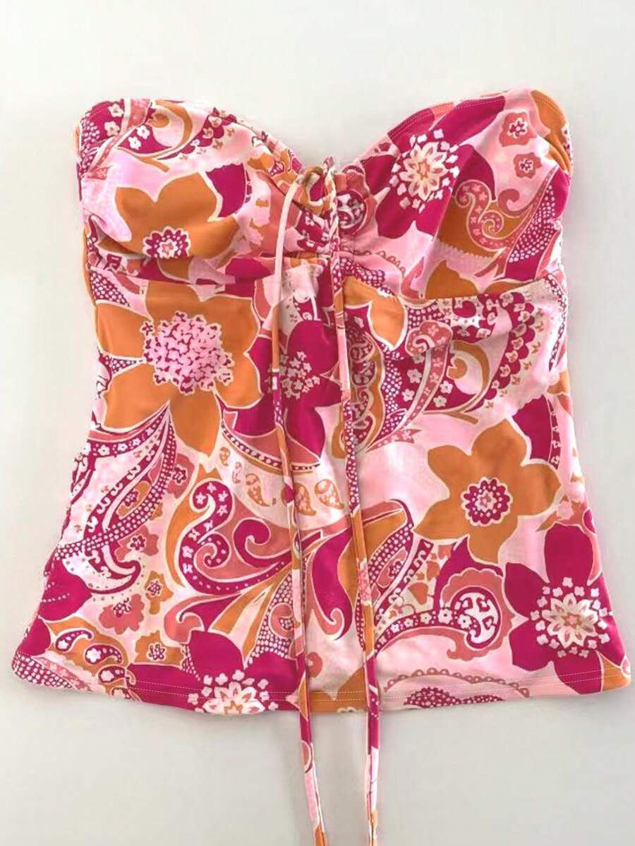 Áo ống màu cam đào in hoa và họa tiết paisley, cổ buộc nơ hình trái tim, kiểu dáng bohemian, thích hợp mặc đi biển mùa hè cho nữ.