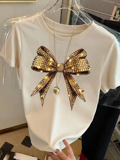 Glänzender Schleifendruck Rundhals Kurzarm T-Shirt. Neues Damen Lässig Süßes Muster Locker Urlaubsstil Vielseitiges Rundhals T-Shirt, Modischer Alltags-Look, geeignet für Feiertage wie Valentinstag, Schulanfang, Lehrertag. Weich, locker und bequem High-End Streetwear Urlaubs Locker Lässig Vielseitiger Kurzarm Top