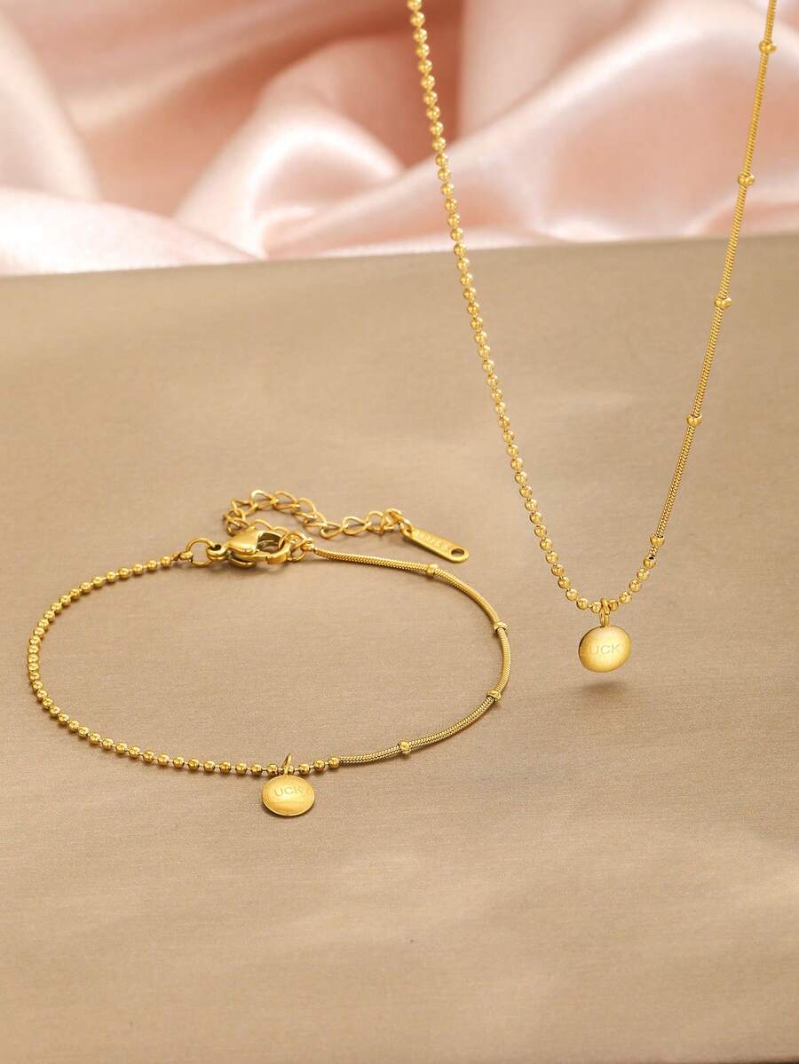 Bộ 2 món dây chuyền và vòng tay bằng thép không gỉ mạ vàng tinh tế với mặt dây chuyền chữ cái may mắn, quà tặng trang sức phù hợp để đeo hàng ngày. - Vàng - Xem 1
