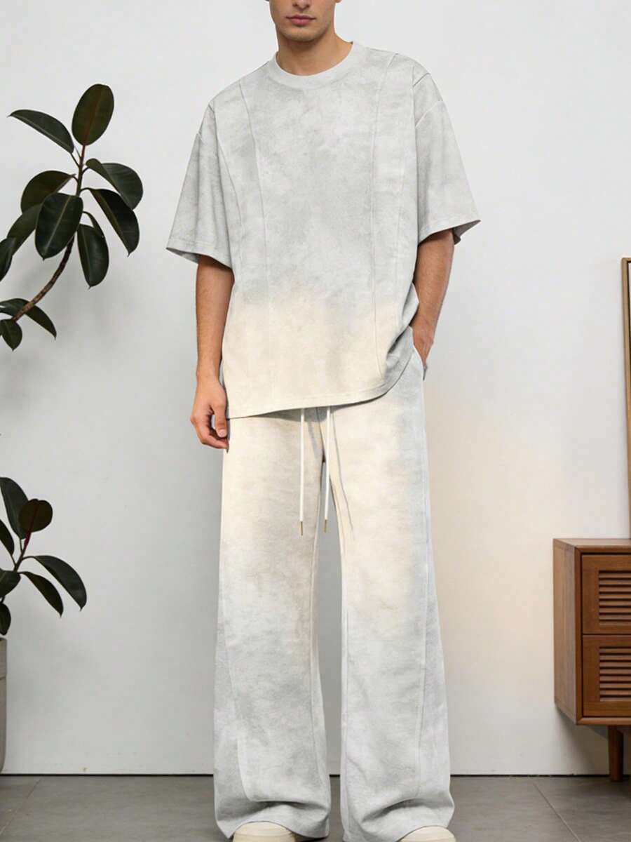 Bộ đồ nam thường ngày gồm áo thun cổ tròn tay lửng và quần ống rộng cạp chun có dây rút. - Màu Xám nhạt - Xem 1