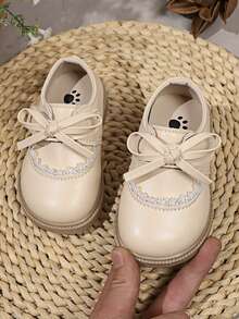 1双米色蝴蝶结可爱时尚珍珠设计软底防滑平底婴儿鞋，适合春、夏、秋、冬四季穿着。 - 米色 - 查看 1