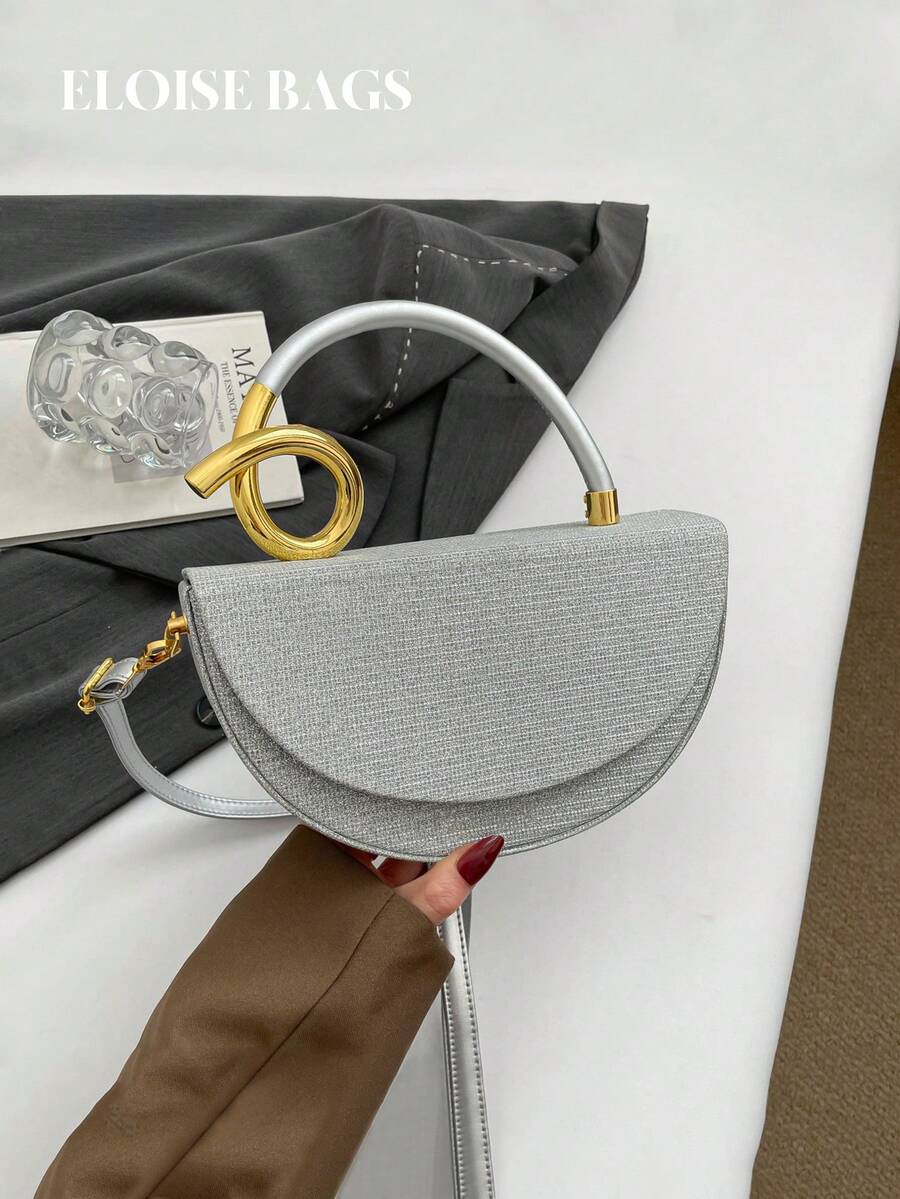 小众奢华设计银色半圆翻盖包，高端金属扭绳手柄手提包，适合晚宴、通勤和约会等场合。