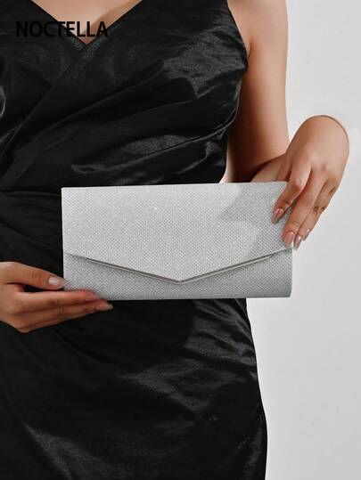 Noctella Luxurious And Sparkling Silver Clutch With Full Glitter Texture And V-Shaped Metal Trim, Boasting A Dazzling Full Glitter Finish, Statement Silver V-Shaped Metal Trim And A Timeless Envelope Shape. Perfect For Formal Balls, Gala Dinners And Red Carpet Events, Making A Bold And Glamorous Statement Effortlessly With Luxurious Silver Hue. It Is The Best Gift For Women
