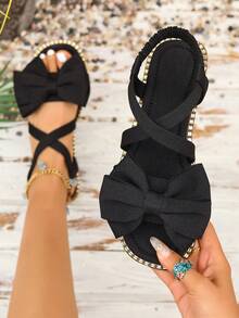 女士黑色蝴蝶结平底凉鞋，新款夏季时尚沙滩度假露趾交叉拖鞋 - 黑色 - 查看 1