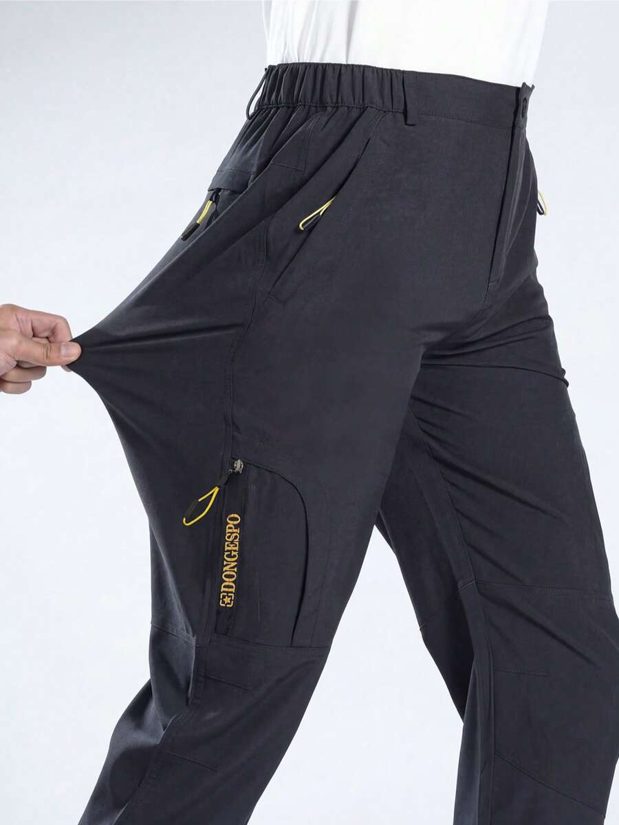 男士多口袋工装裤，拉链口袋设计，直筒裤型，适合户外徒步、露营、钓鱼，春秋季穿着。 - 黑色 - 查看 1