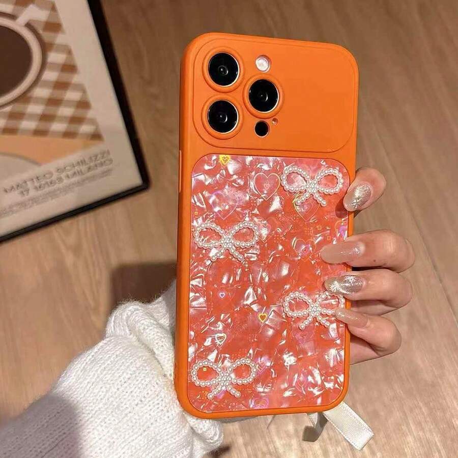 1 pezzo Custodia per telefono arancione alla moda e creativa, in materiale impermeabile e antiurto, con decorazioni laser olografiche a forma di cuore, fiocco 3D in perle, effetto bling bling di lusso, carina e alla moda, compatibile con iPhone serie 17, 11/12/12 Pro, 13/14/15, 13 Pro/14 Pro/15 Pro, 12 Pro Max/13 Pro Max/14 Pro Max/15 Pro Max, 16, 16 Pro, 16 Pro Max, 17, 17 Pro, 17 Pro Max - Arancione - Visualizzare 1