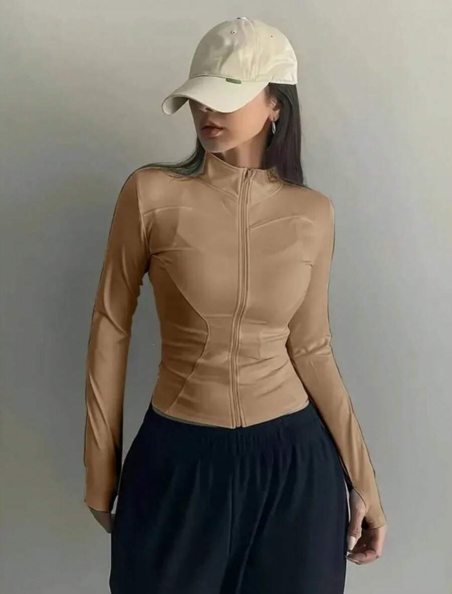 Women's High-Neck Fitness Top With Zipper, Long Sleeves With Thumb Opening, Fitted Design That Flatters The Body, Lightweight, Comfortable And Breathable Fabric, Ideal For The Gym, Workouts, Running, Walking, Yoga And Everyday Wear, Quick-Drying, Soft Touch, High Elasticity, Sporty And Casual Style, Perfect For Creating Fitness Or Urban Looks, Available In Black, Brown, Gray And Nude, Women's Fitness Jacket, Women's Sports Jacket, Women's Gym Top, Women's Workout Clothes, Lightweight Thermal Top, Women's Base Layer, Women's Fitness Fashion, Women's Zip-Up Top, Comfortable Clothing For Workouts And Leisure, Light Wind Protection, Ideal For Mid-Season, Anatomical Fit That Shapes The Silhouette, Versatile To Wear Open Or Closed, Combines With Leggings, Shorts Or Jogger Pants, Perfect For The Gym And Casual Wear, Reinforced Finish, Resistant Seams, Practical Piece For Everyday Wear And Intense Workouts. - Khỏa thân - Xem 1
