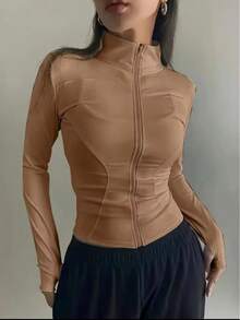 Women's High-Neck Fitness Top With Zipper, Long Sleeves With Thumb Opening, Fitted Design That Flatters The Body, Lightweight, Comfortable And Breathable Fabric, Ideal For The Gym, Workouts, Running, Walking, Yoga And Everyday Wear, Quick-Drying, Soft Touch, High Elasticity, Sporty And Casual Style, Perfect For Creating Fitness Or Urban Looks, Available In Black, Brown, Gray And Nude, Women's Fitness Jacket, Women's Sports Jacket, Women's Gym Top, Women's Workout Clothes, Lightweight Thermal Top, Women's Base Layer, Women's Fitness Fashion, Women's Zip-Up Top, Comfortable Clothing For Workouts And Leisure, Light Wind Protection, Ideal For Mid-Season, Anatomical Fit That Shapes The Silhouette, Versatile To Wear Open Or Closed, Combines With Leggings, Shorts Or Jogger Pants, Perfect For The Gym And Casual Wear, Reinforced Finish, Resistant Seams, Practical Piece For Everyday Wear And Intense Workouts. - Khỏa thân - Xem 2