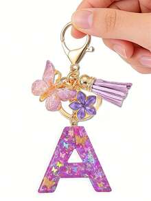 1个紫色蝴蝶字母钥匙扣，饰有闪亮亮片、流苏和珐琅花朵吊坠，时尚手提包挂件，母亲节礼物 - 淡紫色 - 查看 22