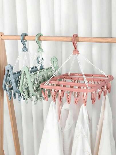 1 قطعة رف ملابس متعدد الوظائف، تصميم موفر للمساحة، قابل للطي، مع 32 مشبك، مريح لتخزين وتجفيف الملابس، رف تجفيف متعدد الوظائف، مشابك بلاستيكية منزلية، رف ملابس متعدد المشابك، يمكن تعليق الملابس والجوارب، عنصر منزلي أساسي، تخزين السفر (ملاحظة: انفصال المشابك أثناء النقل ظاهرة طبيعية ولا تؤثر على جودة المنتج؛ يمكن إعادة تركيب المشابك المنفصلة واستخدامها).