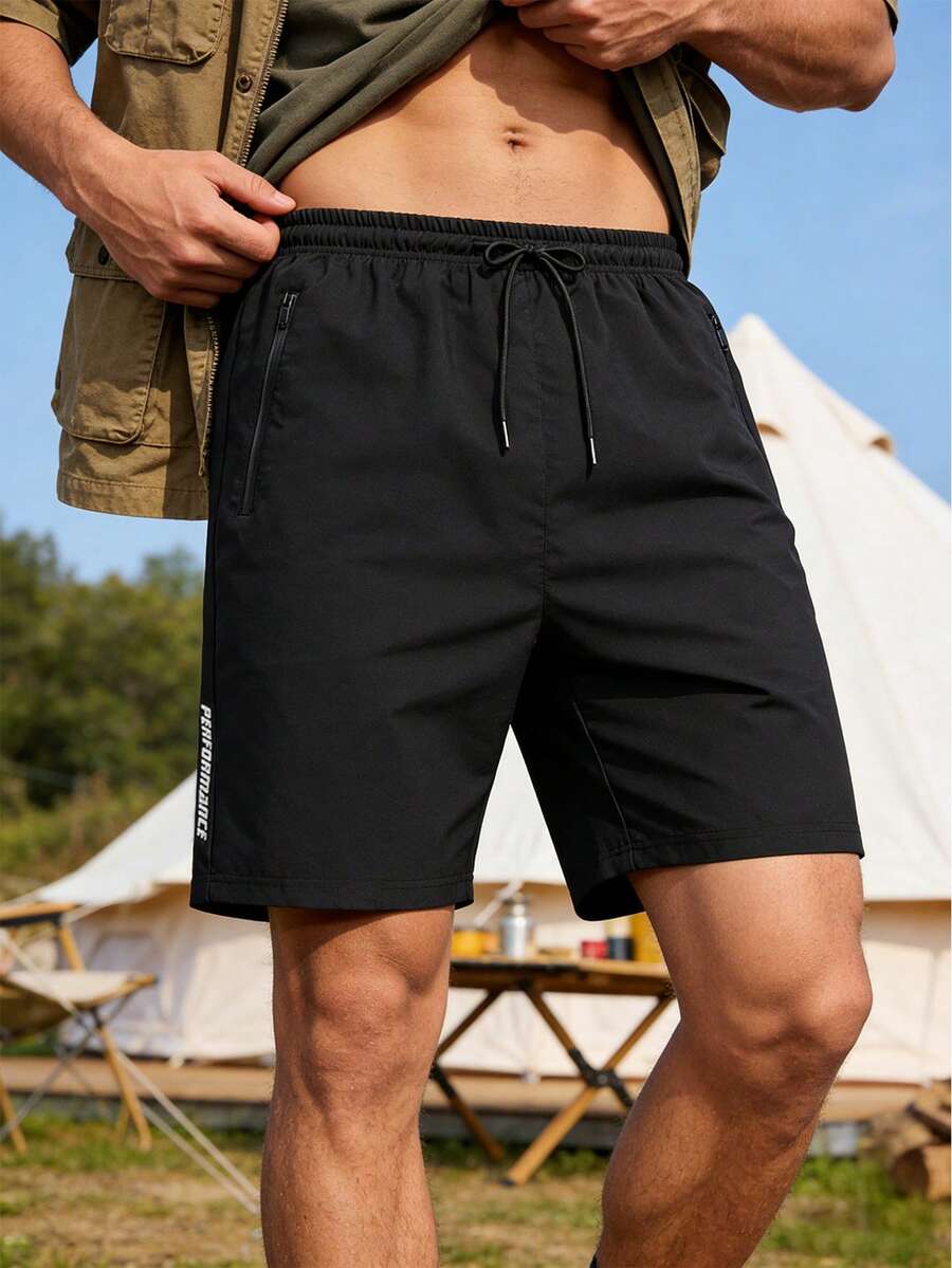 Quần short tập luyện nam dáng rộng, nhanh khô, có in chữ phản quang và túi khóa kéo, thoáng khí và thoải mái, phù hợp cho các bài tập trong phòng gym và các môn thể thao chạy đường dài ngoài trời. - màu đen - Xem 1