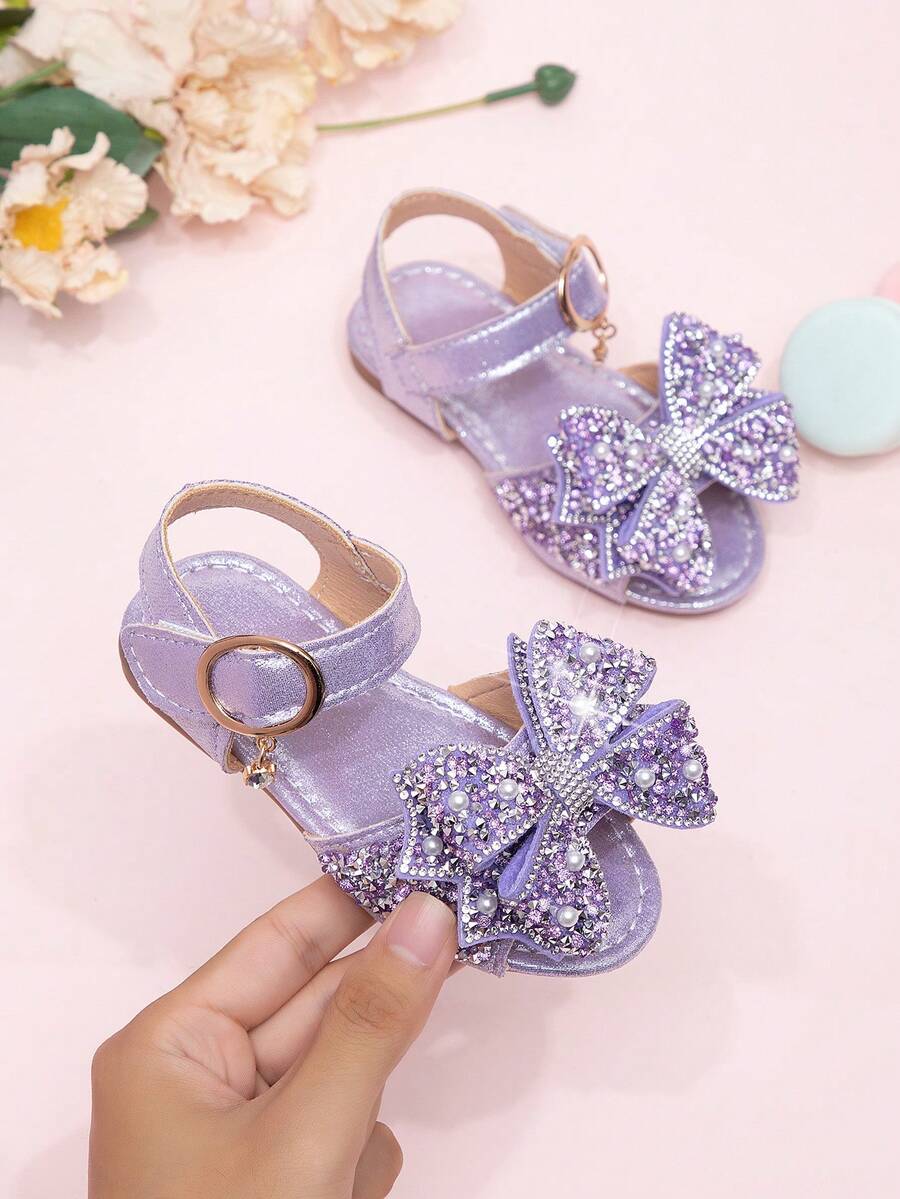 Giày sandal mới năm 2026 cho bé gái, giày công chúa cho trẻ em với nơ đính đá, giày đi biển cho bé gái học sinh, giày mùa hè. - Màu tím - Xem 1