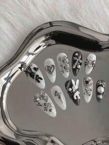 10片中长款杏仁形朋克风自粘美甲贴纸，未来主义金属设计，包含黑白兔子、金属蝴蝶结、蜘蛛、爱心和珍珠链元素，展现性感魅力。 - 黑與白 - 查看 1