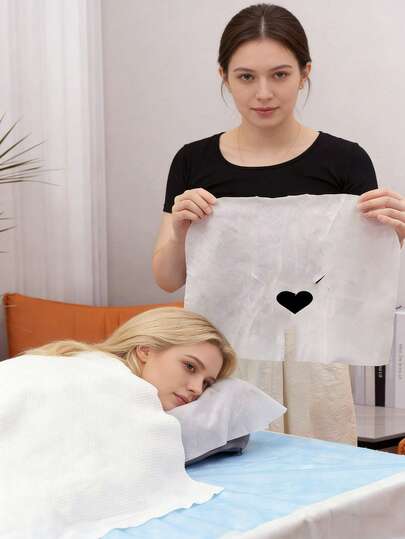 100片一次性按摩床罩，采用柔软无纺布制成，U型脸枕套，心形开口，透气舒适，适用于美容院、水疗中心、按摩垫等。