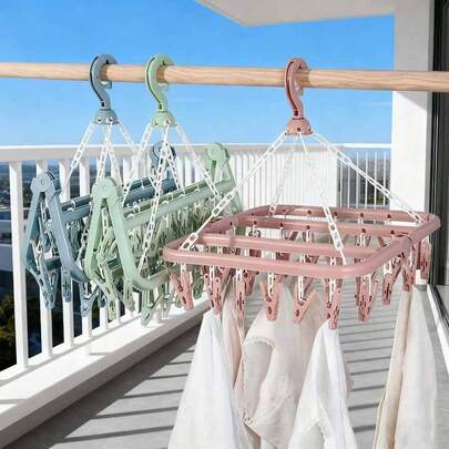 1 pieza Percha colgante multifuncional, diseño ahorra espacio, plegable, con 32 pinzas, conveniente para almacenar y secar ropa, secadora multifuncional, pinzas de plástico para el hogar, percha con múltiples pinzas, puede colgar ropa y calcetines, artículo esencial para el hogar, almacenamiento de viaje (Nota: El desprendimiento de las pinzas durante el transporte es un fenómeno normal y no afecta la calidad del producto; las pinzas desprendidas se pueden volver a instalar y usar).