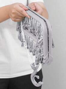 OBOVAY 1 pieza Percha colgante multifuncional, diseño ahorra espacio, plegable, con 32 pinzas, conveniente para almacenar y secar ropa, secadora multifuncional, pinzas de plástico para el hogar, percha con múltiples pinzas, puede colgar ropa y calcetines, artículo esencial para el hogar, almacenamiento de viaje (Nota: El desprendimiento de las pinzas durante el transporte es un fenómeno normal y no afecta la calidad del producto; las pinzas desprendidas se pueden volver a instalar y usar). - Multicolor - Ver 7
