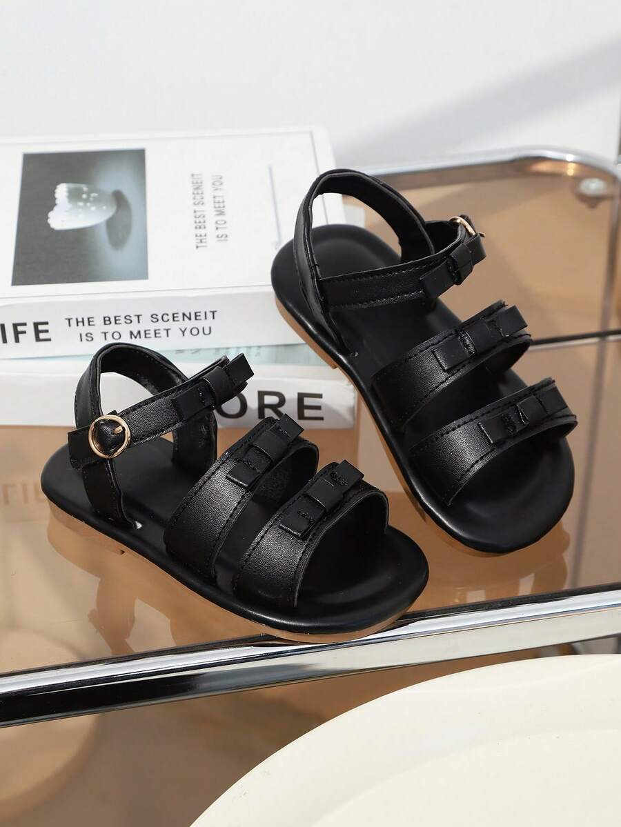 1双黑色女童平底凉鞋，柔软皮革，蝴蝶结装饰，圆头，露趾，柔软防滑鞋底，可调节鞋带，时尚可爱，适合3-12岁女孩，日常、海滩穿着，2026春夏款 - 黑色 - 查看 1