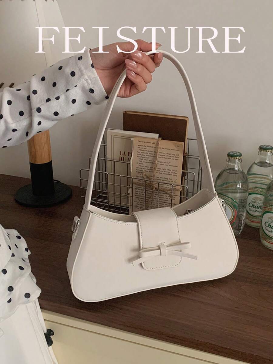 1个FEISTURE PU皮革蝴蝶结翻盖单肩包，时尚女士腋下法棍包，适合日常外出、约会、通勤。
