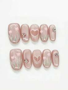 Bộ 10 miếng dán móng tay hình hoa tulip hồng và trái tim đính sequin. Bộ móng này có màu nền hồng nude bán trong suốt kiểu mắt mèo, kết hợp với họa tiết hoa tulip 3D màu hồng, hình trái tim rỗng và điểm xuyết đá lấp lánh. Lớp phủ bóng phản chiếu vẻ ngọt ngào và thanh lịch như những cánh hoa tulip dưới ánh nắng dịu nhẹ, tạo cảm giác lãng mạn và tươi mới. - Màu Hồng baby - Xem 1