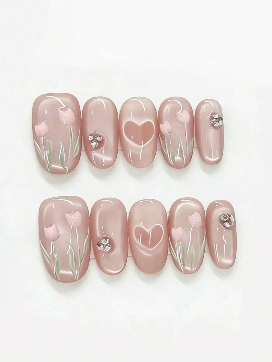 Bộ 10 miếng dán móng tay hình hoa tulip hồng và trái tim đính sequin. Bộ móng này có màu nền hồng nude bán trong suốt kiểu mắt mèo, kết hợp với họa tiết hoa tulip 3D màu hồng, hình trái tim rỗng và điểm xuyết đá lấp lánh. Lớp phủ bóng phản chiếu vẻ ngọt ngào và thanh lịch như những cánh hoa tulip dưới ánh nắng dịu nhẹ, tạo cảm giác lãng mạn và tươi mới. - Màu Hồng baby - Xem 1