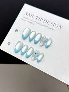 10片纯手工制作的按压式美甲贴片，短款杏仁形，风格清新简约。饰有手绘灰白色烟花猫眼图案，搭配清新蓝色法式甲尖，以及手绘立体蓝白花朵。这是一款高端美甲贴片，适合女士和女孩日常佩戴，并附赠美甲工具包。 - 彩色 - 查看 1