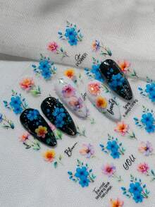 水彩风格的春季花卉艺术作品，以各种花卉图案为特色，包括簇拥的蓝色花朵、渐变橙色单瓣花和渐变紫色多瓣花，并配以“你”、“绽放”、“美丽”、“最盛放的时节已至”、“春天总会到来”、“春天是个奇迹”和“女孩力量”等振奋人心的英文短语，营造出轻松、浪漫和充满希望的氛围，适合春季时尚和手账装饰美甲贴纸。 - 彩色 - 查看 7