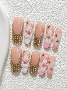 10件套奢华贵族风手工美甲套装，包含凝胶美甲套装、五瓣白花粉色花蕊装饰、香槟色不对称小钻石图案、手绘粉白树枝装饰，四季皆宜，附赠1张果冻贴纸和1把指甲锉，三种形状可选：杏仁形、鸭嘴形、棺材形。 - 彩色 - 查看 11