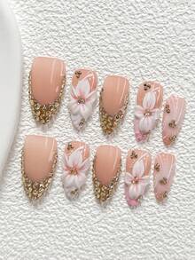 10件套奢华贵族风手工美甲套装，包含凝胶美甲套装、五瓣白花粉色花蕊装饰、香槟色不对称小钻石图案、手绘粉白树枝装饰，四季皆宜，附赠1张果冻贴纸和1把指甲锉，三种形状可选：杏仁形、鸭嘴形、棺材形。 - 彩色 - 查看 15