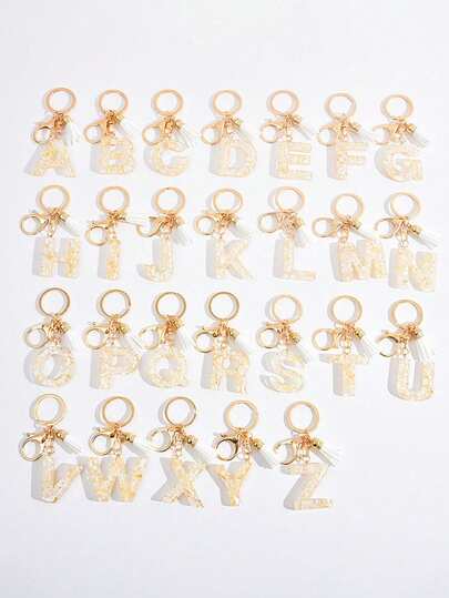 1pc Apricot Heart Tassel Initial Keychain, First Letter Keyring, Gold Foil Uppercase Letter Resin Keychain Pendant, Butterfly Tassel Charm, Fashion Keychain, Outdoor Backpack Decoration DIY Outdoor Backpack Hanging Keychain, Suitable As Gift For Friends